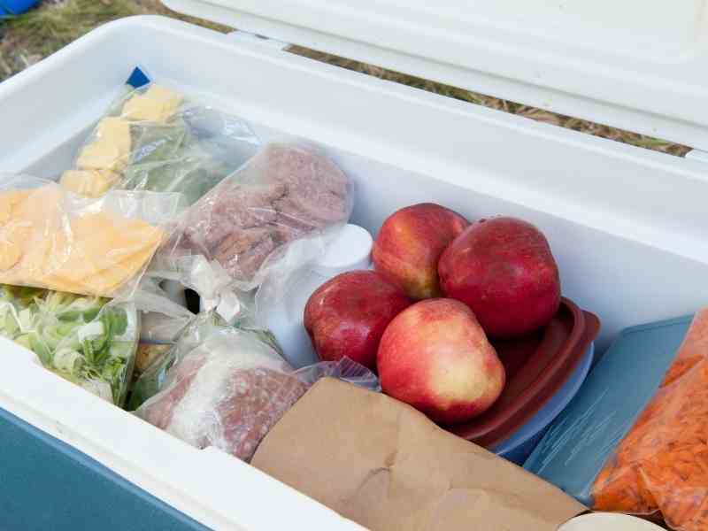 food that being kept cold in a cooler box while camping